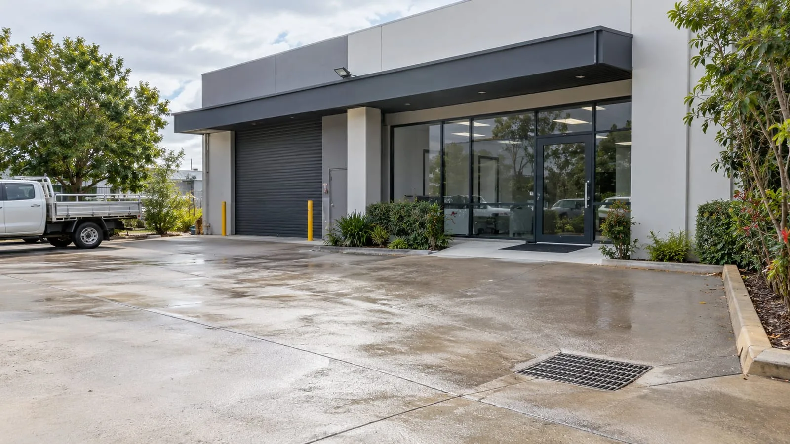 AI-generated illustration: Stafford small commercial building frontage with practical forecourt stormwater drainage